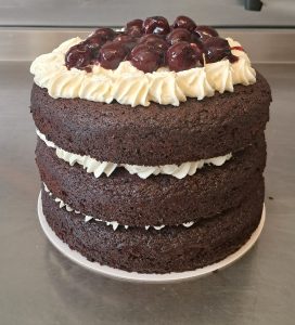 Vegan Black Forest Gateau with 3 layers of chocolate sponge, black cherries, and clotted cream